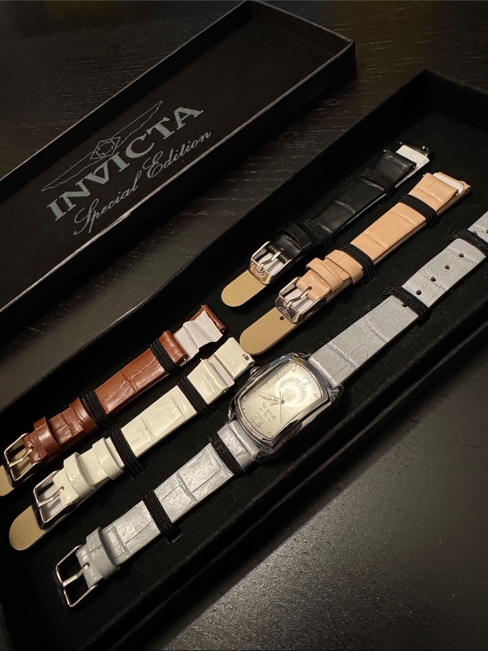 Invicta Watch with Silver Face and Multiple Black, Tan, Brown, White Straps
